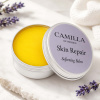 Camilla of Sweden Skin Repair Balm Lifestyle Image Open Skin Repair Softening Balm tin styled with lavender