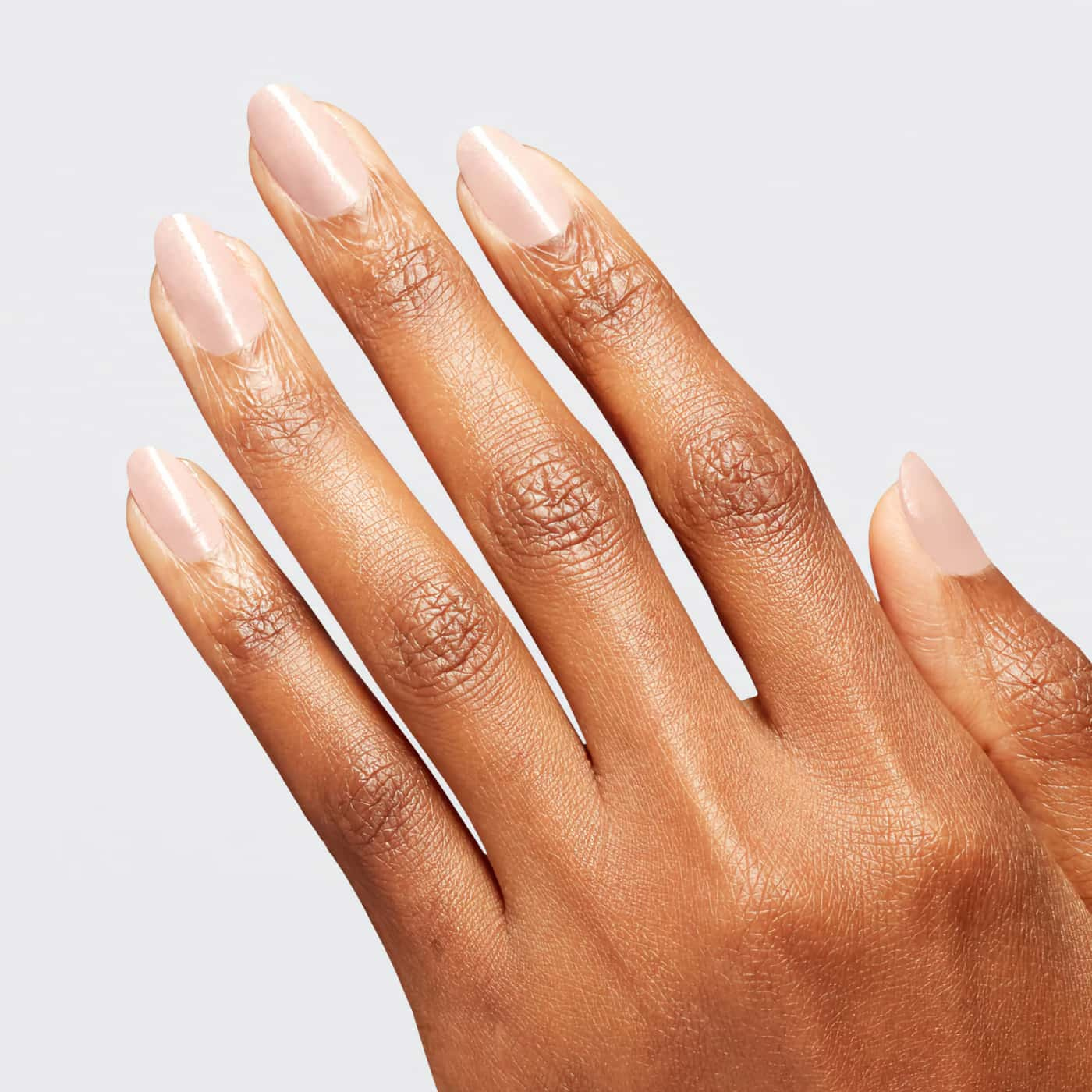 Light pink nail polish with subtle shimmer from OPI Wicked collection, ideal for a glamorous and sophisticated manicure.