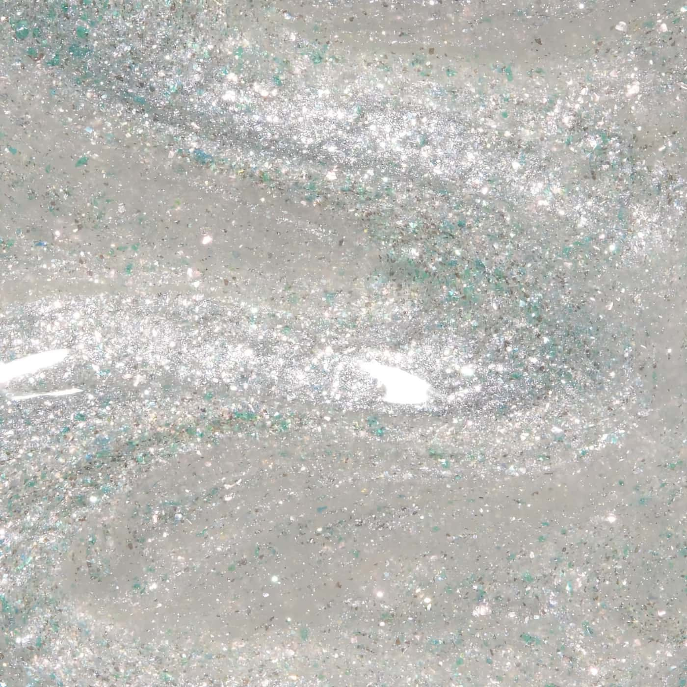 Sheer nail polish with blue, green, and silver glitter from OPI Wicked collection, ideal for a shimmering, magical look.