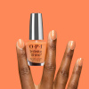 OPI IS Dreamsicle - Orange glitter polish OPI IS Dreamsicle - Orange nail polish with golden glitter for a vibrant and energetic manicure