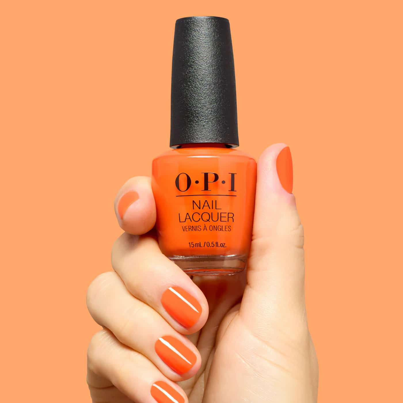 Neon orange nail polish with warm citrus undertones and creamy finish for bold summer nails.